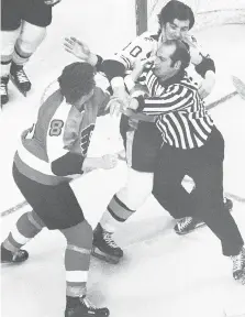  ?? THE ASSOCIATED PRESS/FILES ?? Back in 1974, fights were common, even in the playoffs, such as when Philadelph­ia Flyers tough guy Dave Schultz tried to pull linesman John D’Amico out of the way to get to Boston’s Carol Vadnais.