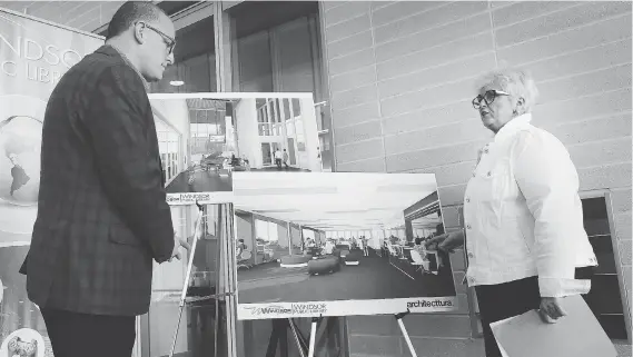  ?? DAN JANISSE ?? Mayor Drew Dilkens, left, and Kitty Pope, chief executive officer of the Windsor Public Library, announce the temporary location for the central library branch in the new city hall.