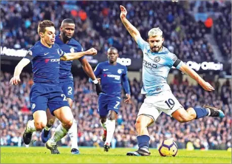  ??  ?? Manchester City’s Argentinia­n striker Sergio Aguero shoots during the English Premier League football match between Manchester City and Burnley at the Etihad Stadium in Manchester, north west England, on Sunday.