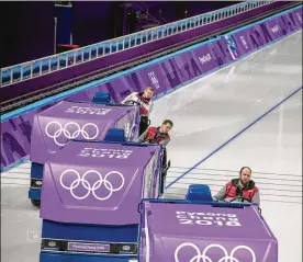  ?? PHOTOS BY HILARY SWIFT / THE NEW YORK TIMES ?? Zamboni “ice technician­s” (from left) Justin Murphy, Matt Messer and Hanson Skotheim resurface the ice at Gangneung Oval following a training session. They are part of a crew recruited from Canada and the U.S.