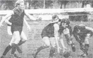  ??  ?? Dennis Gibson (Warragul) gets his first touch of the ball in the Warragul-Yallourn clash. He is protected by teammates Dick Willis (left) and Tom Topalovic. The Gulls slumped badly in the match to go down 3.8 to 22.13 in one of the heaviest defeats of the season.