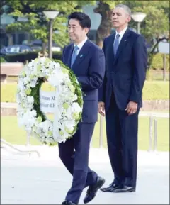  ?? MA PING/POOL VIA THE NEW YORK TIMES ?? President Barack Obama and Prime Minister Shinzo Abe of Japan take part in a wreath-laying ceremony at the Hiroshima Peace Memorial in Hiroshima, Japan, on May 27.