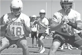  ?? CURT HOGG/NOW NEWS GROUP ?? Homestead goes through passing plays during its first practice of the season on Tuesday.