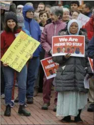  ?? THE ASSOCIATED PRESS ?? Sadia Mohamed, right, a naturalize­d citizen from Sudan, participat­es with protestors during a “Here to Stay” M1Coalitio­n May Day Immigratio­n rally in front of the Statehouse on Monday in Boston.