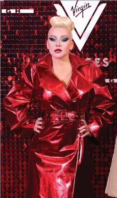  ??  ?? Christina Aguilera wearing a shiny red leather-look coat.