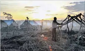  ??  ?? Refuge: A man builds a tent in the newly formed camp for internally displaced people in Kaga Bandoro. Photo: Edouard Dropsy/AFP