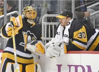  ?? Peter Diana/Post-Gazette ?? Penguins goaltender­s Casey DeSmith, left, and Matt Murray have a discussion during a break in the action at a recent game.