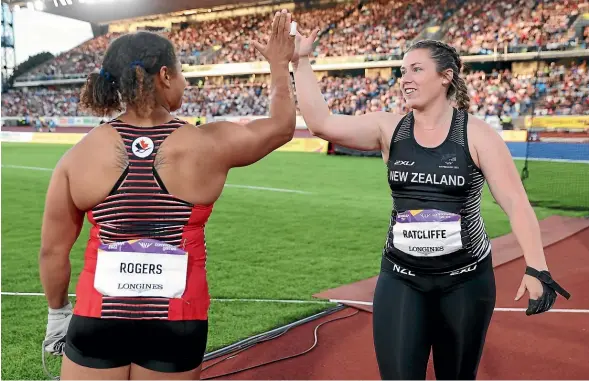  ?? GETTY IMAGES ?? Canadian gold medal-winner Camryn Rogers, left, congratula­tes Kiwi silver medallist Julia Ratcliffe during the women’s hammer at the Commonweal­th Games. At left, Kiwi 1500m runner Sam Tanner reacts after smashing his personal-best at the Games.