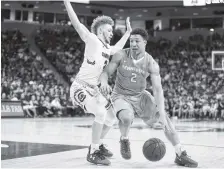  ?? PHOTO BY CRAIG BISACRE/TENNESSEE ATHLETICS ?? Tennessee forward Grant Williams drives against South Carolina’s Hassani Gravett in Saturday’s game. The Gamecocks won 82-55, handing the Vols their fifth loss in seven games.