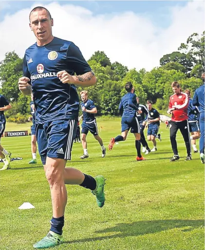  ??  ?? Scott Brown, above, leads the way in training after praising manager Gordon Strachan for helping to reignite his career; Stuart Armstrong, who will likely win his second internatio­nal cap against England, and Robert Snodgrass, right, are put through...