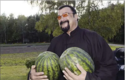  ?? ANDREI STASEVICH — POOL PHOTO VIA AP ?? In this photo taken Wednesday Hollywood actor and producer Steven Seagal holds two watermelon­s in the Belarus’ presidenti­al residence of Drozdy, outside Minsk, Belarus. Belarus’ farm-loving President Alexander Lukashenko has treated American action...