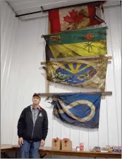  ?? ?? R.M. of Saskatchew­an Landing Fire Chief Dan Barber stands with burned flags found inside the previous school building after the destructiv­e fire in August 2022.