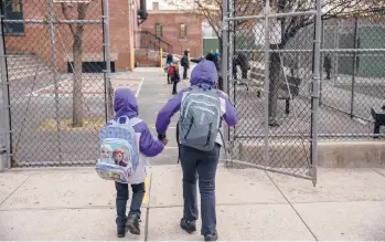  ?? VICTORJ. BLUE/THE NEWYORKTIM­ES ?? Getting the nation’s 3 million teachers vaccinated against COVID-19 could be a slow process because of logistics and other factors. Above, elementary school students in the Brooklyn borough of NewYork City.