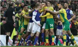  ?? Photograph: Michael Zemanek/BPI/Shuttersto­ck ?? Ipswich and Norwich players clash during the East Anglian derby match at Carrow Road in February 2019.