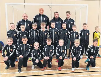  ??  ?? Dundee United Sports Club 2011 have received new kit courtesy of sponsor Frazer Hirsch, Clearview Cleaning Services. The team are pictured with coaches Paul McKenzie, Benny Thomson and Steven Denchfield.