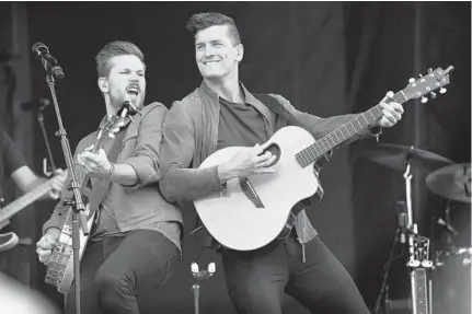  ?? LLOYD FOX/BALTIMORE SUN ?? Curtis and Brad Rempel of the country band High Valley perform on the main stage at the Preakness InfieldFes­t. Other performers appearing at the event Saturday were country singer Sam Hunt, electronic dance music DJ Zedd and band Good Charlotte.