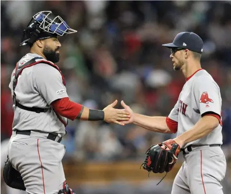  ?? ASSOCIATED PRESS ?? FINISHING TOUCH: Sandy Leon shakes hands with Marcus Walden after closing out last night’s 5-4 victory.