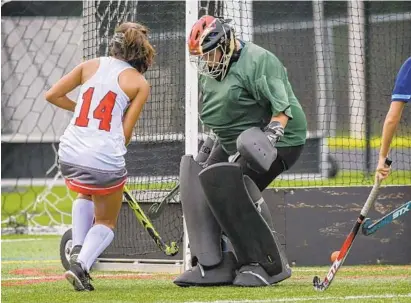  ?? DOUG KAPUSTIN/BALTIMORE SUN MEDIA GROUP ?? Glenelg’s Tess Muneses puts a shot behind River Hill goalie Caroline Kral for the game’s final score in the Gladiators’ 2-0 victory.