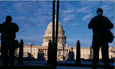  ?? TNS ?? National Guard troops stand behind security fencing with the dome of the U.S. Capitol Building behind them on Jan. 16, in Washington, D.C. The events that took place on Jan. 6 were shocking to any true American patriot, but the insurrecti­on was only one part of a much larger effort to undermine democracy, the author writes.