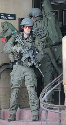  ??  WAYNE CUDDINGTON/OTTAWA CITIZEN FILES ?? RCMP tactical officers attempt to enter the Langevin Block on Oct. 22 as police respond to reports of a gunman and shooting on Parliament Hill.