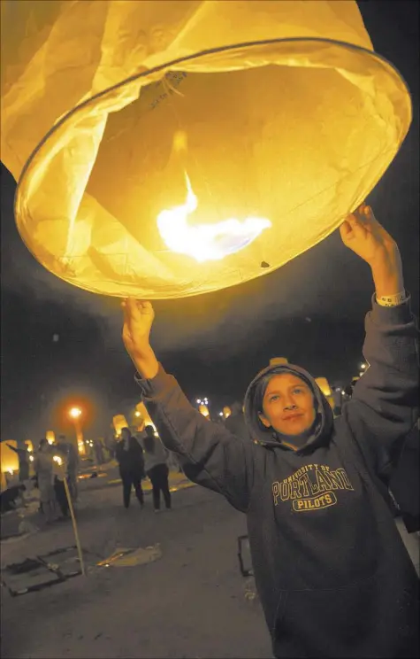  ?? Richard Brian Las Vegas Review-Journal @vegasphoto­graph ?? Abigail Arres, 11, from California, releases a lantern at the RiSE Festival held at the Moapa River Indian Reservatio­n in 2017. This year’s festival will be held at the Jean Dry Lake Bed.