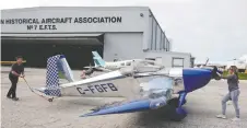  ??  ?? Hangar volunteers assist with Perry Burford’s RV-7 in order to prepare for the Inspiratio­nal Flight and Tribute to front-line workers.