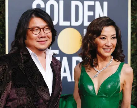  ?? (Mike Blake/Reuters) ?? AUTHOR KEVIN KWAN and ‘Crazy Rich Asians’ star Michelle Yeoh are all smiles at the 76th Golden Globe Awards in Beverly Hills last year.