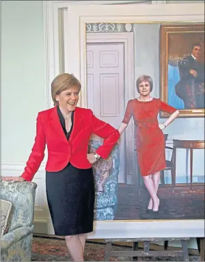  ??  ?? STRIKING A POSE: Nicola Sturgeon with the new portrait by artist Gerard Burns. Picture: Gordon Terris