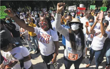  ?? John Bazemore / Associated Press 2020 ?? People protested the shooting of Ahmaud Arbery, an unarmed black man, in Brunswick, Ga., last year.