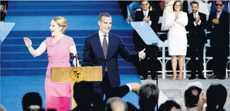  ?? Gary Coronado Los Angeles Times ?? MAYOR Eric Garcetti and his wife, Amy Wakeland, greet the crowd outside L.A. City Hall before his swearing-in for his second term.