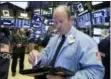  ?? RICHARD DREW — THE ASSOCIATED PRESS ?? Trader Peter Mancuso works on the floor of the New York Stock Exchange on Thursday.