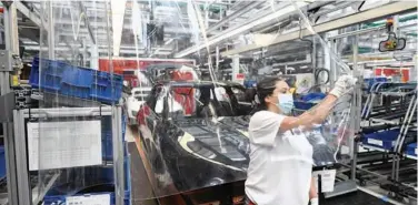  ?? ?? ↑
An employee works at the production line of the German car manufactur­er Audi in Ingolstadt, Germany.