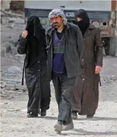  ?? Photo: Getty ?? Civilians walk in Douma yesterday.