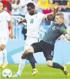  ??  ?? Nigeria captain John Obi Mikel (10) fights for the ball with Germany’s Lars Bender during the semi-final match of the 2016 Rio Olympic Games football event