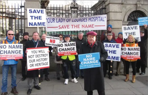  ??  ?? Mayor Frank Godfrey and a number of protestors associated with the ‘Save the Name’ group standing outside Dail Eireann last week as part of their campaign to retain the name of the hospital.