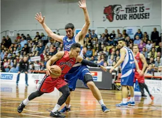  ?? PHOTO: DAVID WALKER/FAIRFAX NZ ?? Marcus Alipate drives past a Saints defender during last night NBL match at Cowles Stadium.