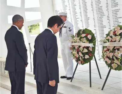  ?? NICHOLAS KAMM, AFP/GETTY IMAGES ?? President Obama and Japanese Prime Minister Shinzo Abe place wreaths at the USS Arizona Memorial.