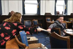  ?? (AP/Mark Hertzberg) ?? Kyle Rittenhous­e and his mother, Wendy Rittenhous­e, exchange documents Tuesday before his trial in Kenosha, Wis., in the killing of two people during anti-racism protests last year.