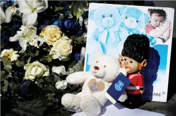  ??  ?? Tributes are seen before the funeral cortege of Alfie Evans passes Goodison Park, the home stadium of soccer club Everton, in Liverpool, Britain. — Reuters photo