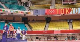  ?? Robert Gauthier Los Angeles Times ?? NAOHISA TAKATO is joined on the podium with other medalists after winning the gold medal in the men’s judo 60g tournament in front of a nearly empty arena.