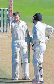  ??  ?? New Zealand captain Kane Williamson (L) celebrates his century with Henry Nicholls during Day Five of the first Test. AFP