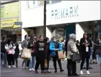  ??  ?? Shoppers queue outside Primark in Nottingham