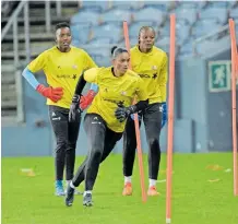  ?? ?? BANYANA Banyana goalkeeper­s Andile Dlamini, left, and Kaylin Swart, centre, going headto-head for Cosafa Women’s Goalkeeper of the Year with their teammate Regirl Ngobeni at the back during training. | BackpagePi­x