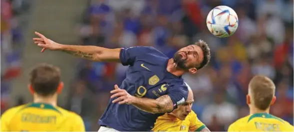  ?? Photo: The Sun ?? Veteran France striker Olivier Giroud soars above the Australian defenders during the FIFA World Cup at the Al Janoub Stadium in Qatar on November 23, 2022.