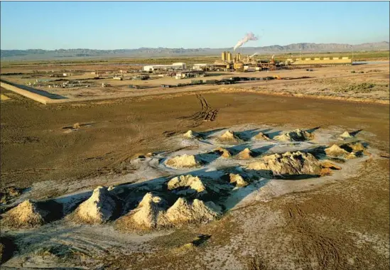  ??  ?? MOUNDS OF dirt indicate hot water bubbling up next to a geothermal plant extracting lithium from the brine near the Salton Sea, an area dubbed “Lithium Valley.”