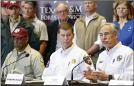  ?? (AP/The Dallas Morning News/Elias Valverde II) ?? Texas Gov. Greg Abbott (right) speaks Friday during a news conference about the panhandle wildfires alongside Al Davis, Texas A&M Forest Service director (far left); and Chief Nim Kidd, Texas Division of Emergency Management, in Borger, Texas.