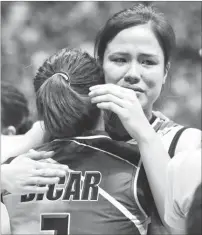  ?? (Rio Deluvio) ?? SANTO Tomas’ Pam Lastimosa, right, weeps as she hugs teammate Alina Bicar after bowing to De La Salle, 25-24, 25-20, 24-26, 25-23, in the semifinals of UAAP women’s volleyball Saturday at the Smart Araneta Coliseum.