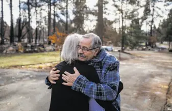  ?? Gabrielle Lurie / The Chronicle ?? Left: Frank Matoes hugs neighbor Phyllis Bremer as he sees her for the first time since their homes burned.