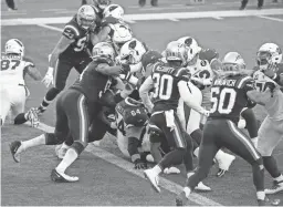  ?? AP ?? Patriots defenders stop Cardinals running back Kenyan Drake short of the goal line to end the first half on Sunday in Foxborough, Mass.