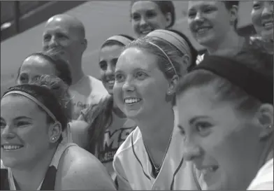  ??  ?? Never gave up: In this Oct. 23, 2014, file photo, Lauren Hill, center, poses for a photo with her teammates after practicing with the NCAA college basketball team at Mount St. Joseph University in Cincinnati. The 19-year-old freshman basketball player...